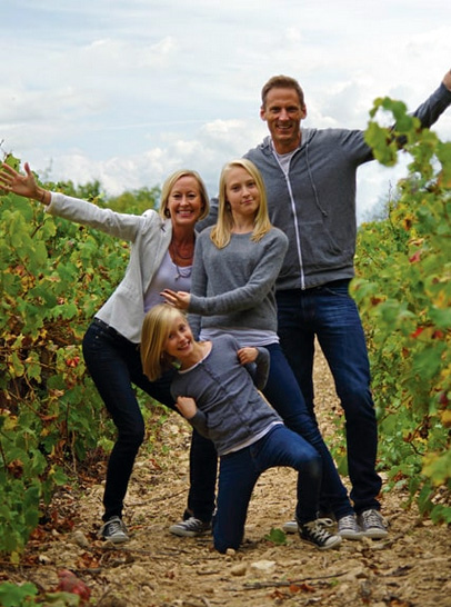 About Aixploring Provence Family Posing in a Field of Grape Vines